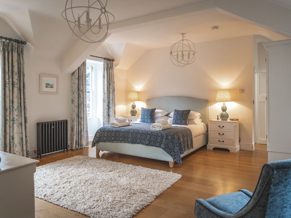 A bedroom with a bed and nightstands at Tan Llan in Llanelltyd near Dolgellau