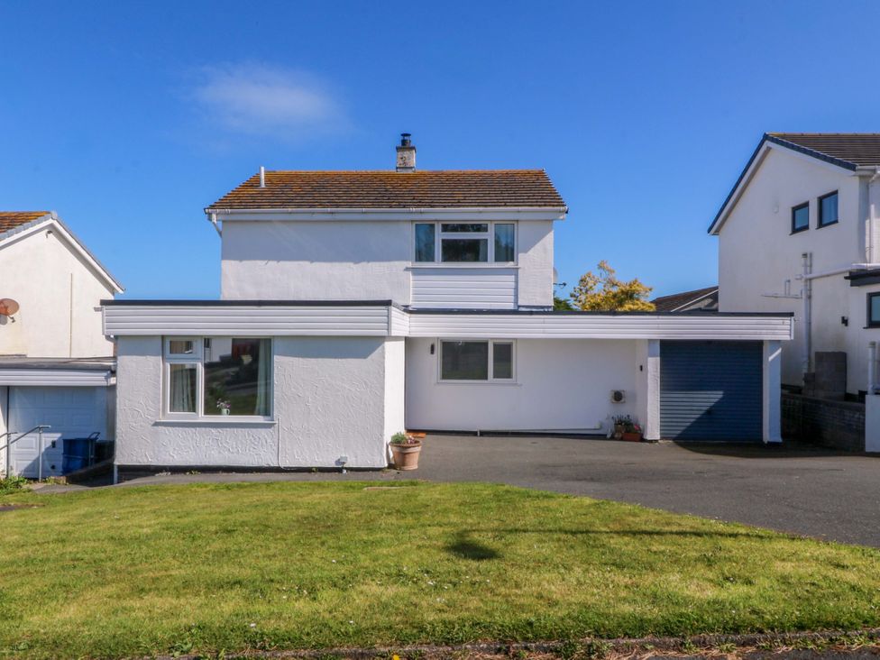 A house with a garage and lawn at 20 Gwelfor Estate Cemaes Bay