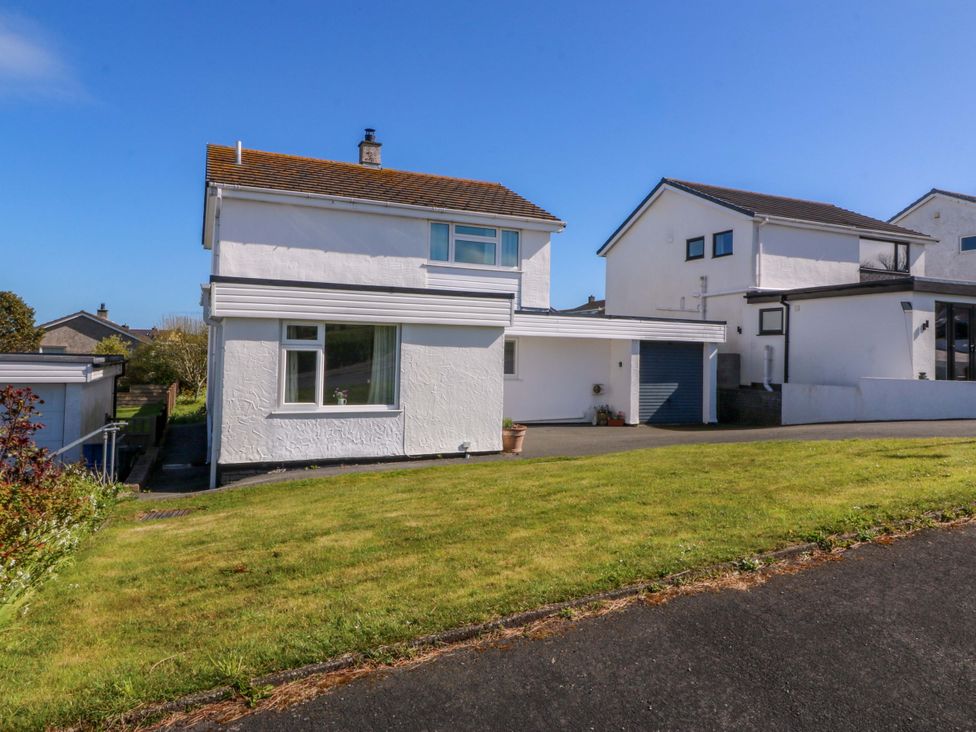 A house exterior with a garage and lawn at 20 Gwelfor Estate Cemaes Bay