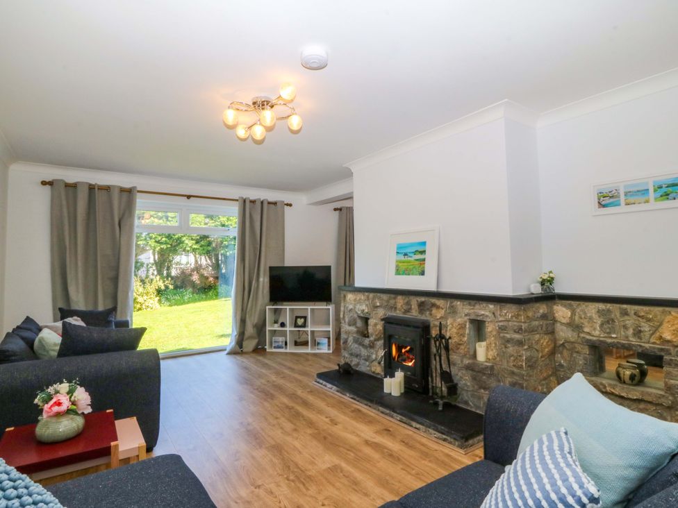 A living room with a fireplace and television at 20 Gwelfor Estate Cemaes Bay