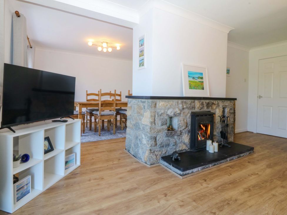 A living room with a television and a fireplace at 20 Gwelfor Estate in Cemaes Bay