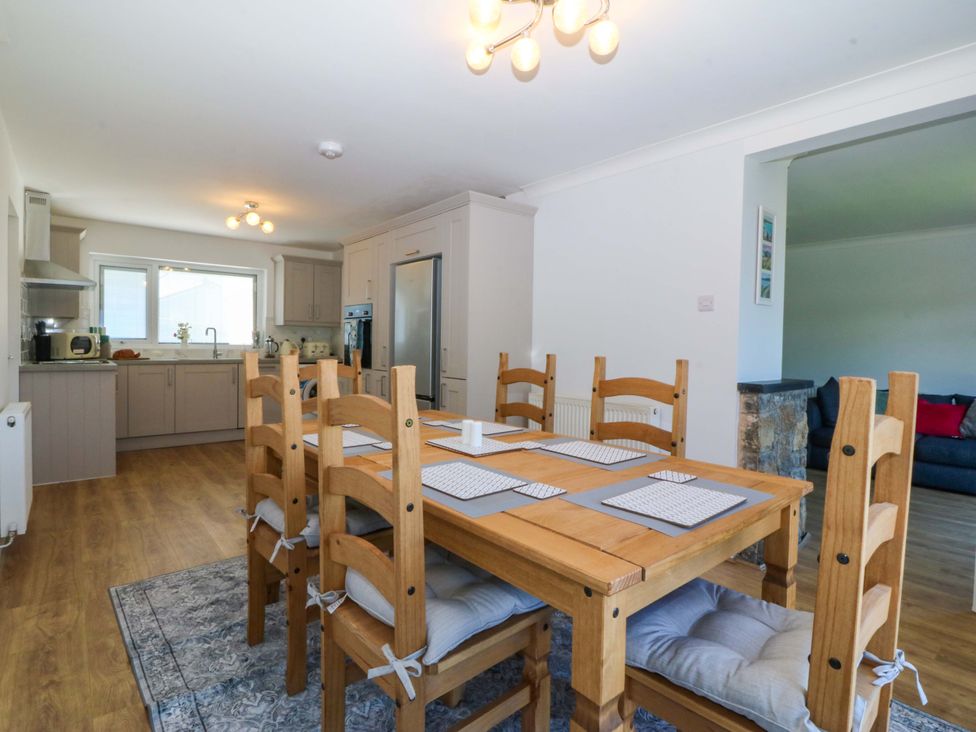 A kitchen with a dining table and chairs at 20 Gwelfor Estate Cemaes Bay