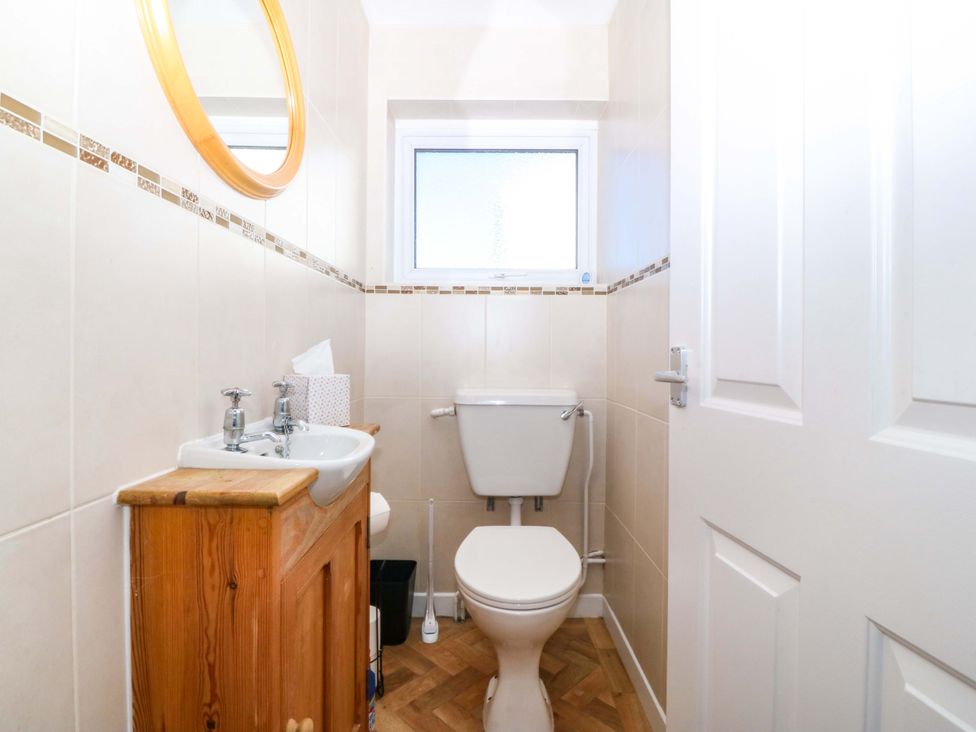A bathroom with a sink and toilet at 20 Gwelfor Estate in Cemaes Bay