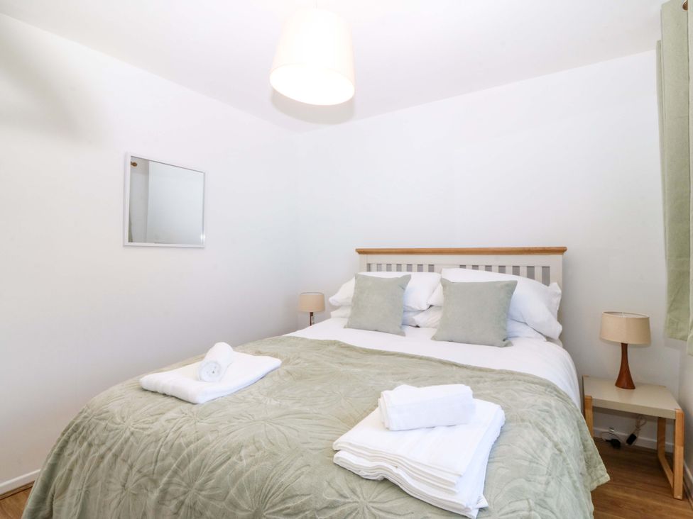 A bedroom with a bed and lamp at 20 Gwelfor Estate Cemaes Bay