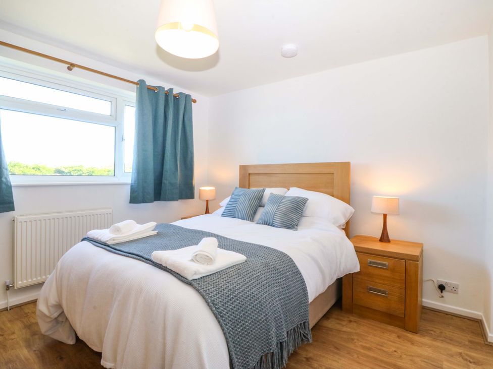 A bedroom with bed and bedside table at 20 Gwelfor Estate in Cemaes Bay