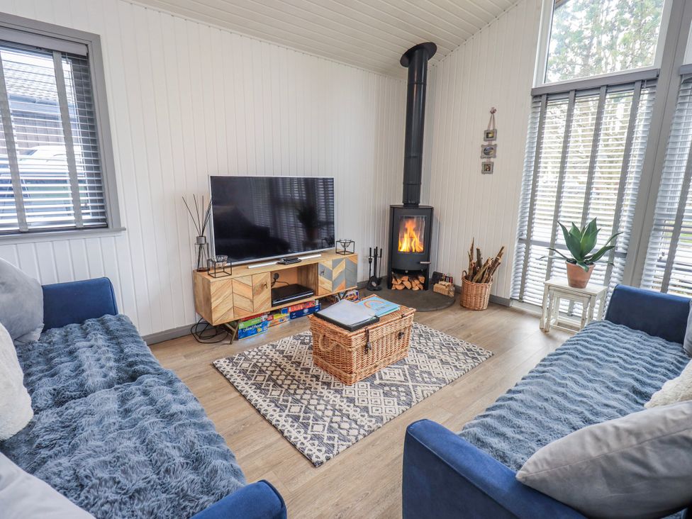 A living room with a television and fireplace at Fig Tree Lodge Hutton Roof near Penrith