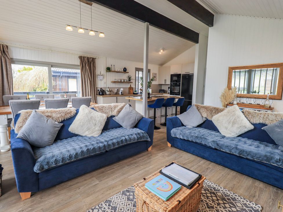 A living room with two sofas and a dining area at Fig Tree Lodge Hutton Roof near Penrith
