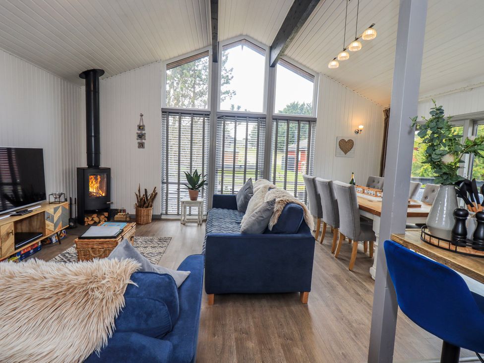 A living room with a sofa and television at Fig Tree Lodge Hutton Roof near Penrith