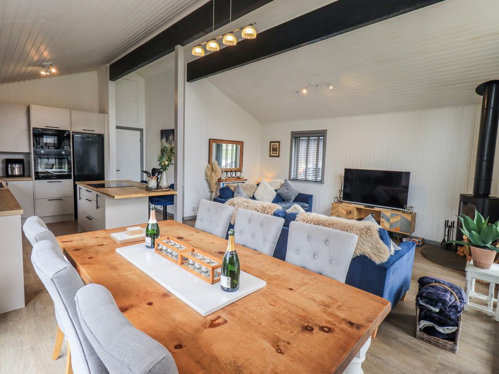 A living room with a kitchen area at Fig Tree Lodge Hutton Roof near Penrith