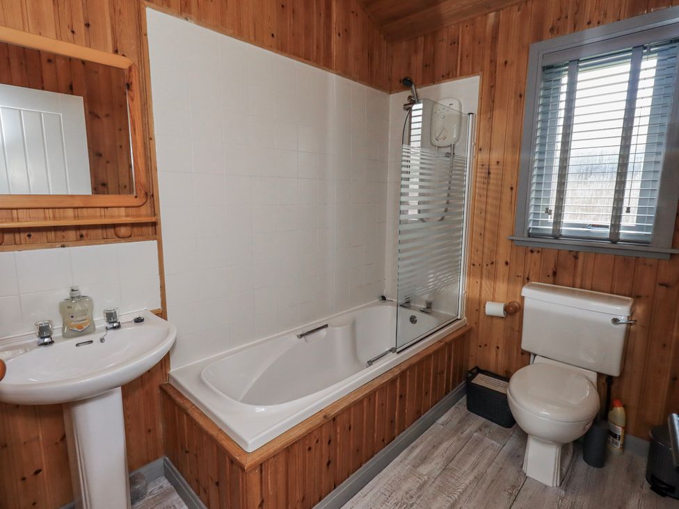 A bathroom featuring a bathtub, sink, toilet, and shower at Fig Tree Lodge in Hutton Roof near Penrith