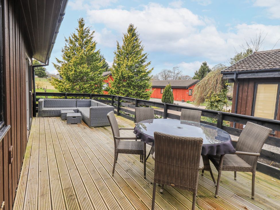 A patio with seating arrangements at Fig Tree Lodge Hutton Roof near Penrith