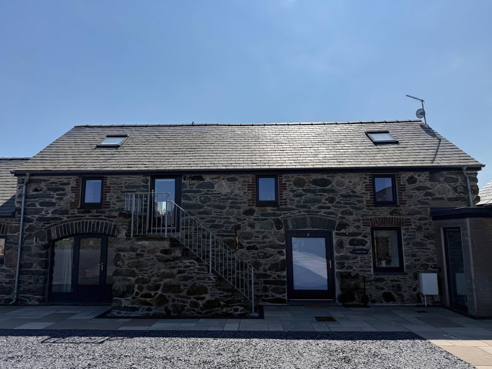 A building with stairs and windows at 3 Trem y Mor Llanfwrog near Llanfachraeth