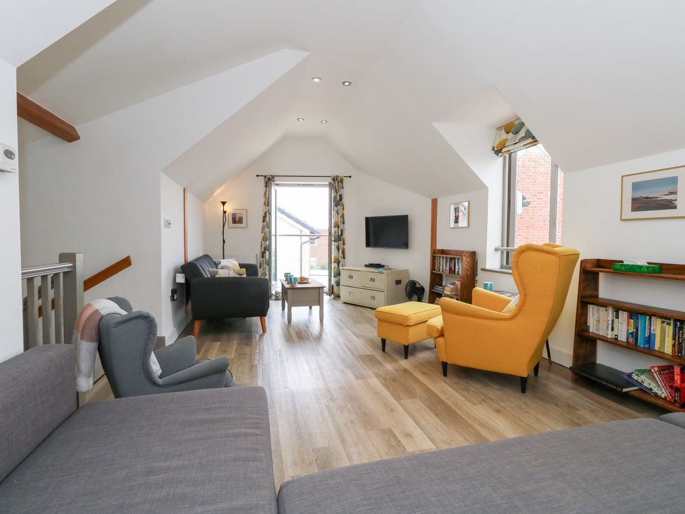 A living room with furniture and a window at Coastguard Lookout in Wyke Regis