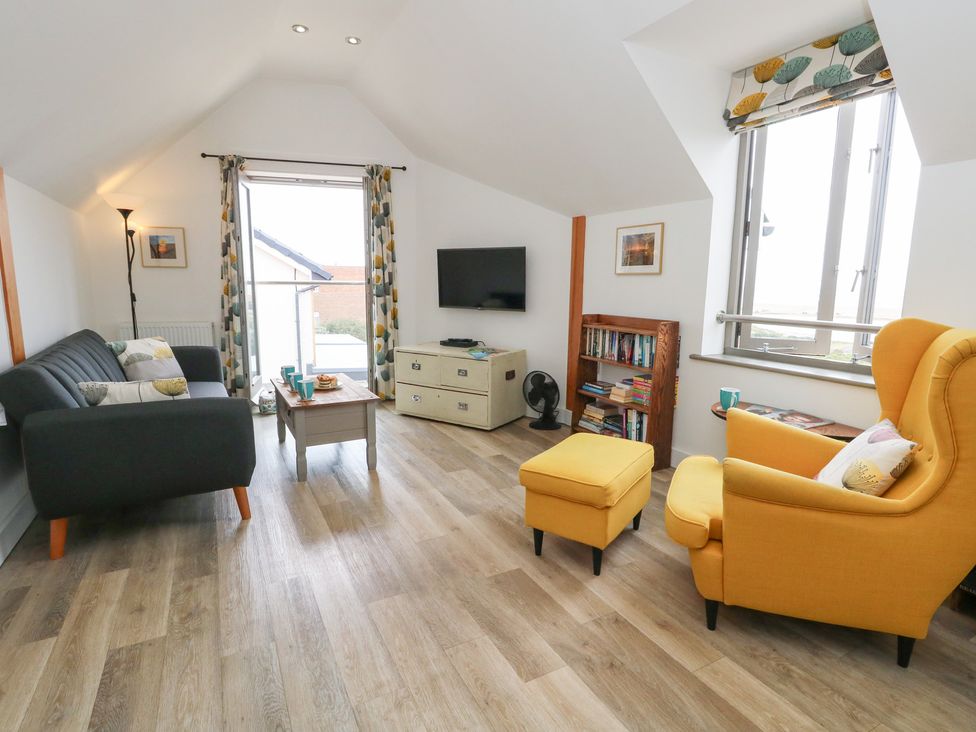 A living room with a sofa and armchair at Coastguard Lookout in Wyke Regis