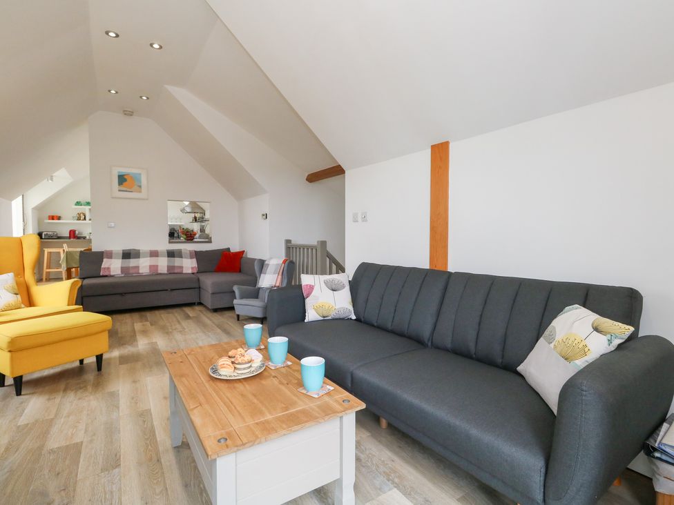 A living room with a sofa and armchair at Coastguard Lookout in Wyke Regis