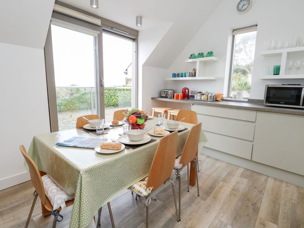 A kitchen with table and chairs at Coastguard Lookout in Wyke Regis