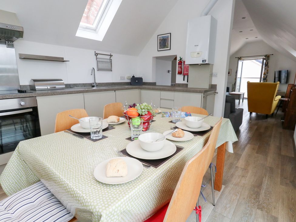 A kitchen with a table set for a meal at Coastguard Lookout in Wyke Regis