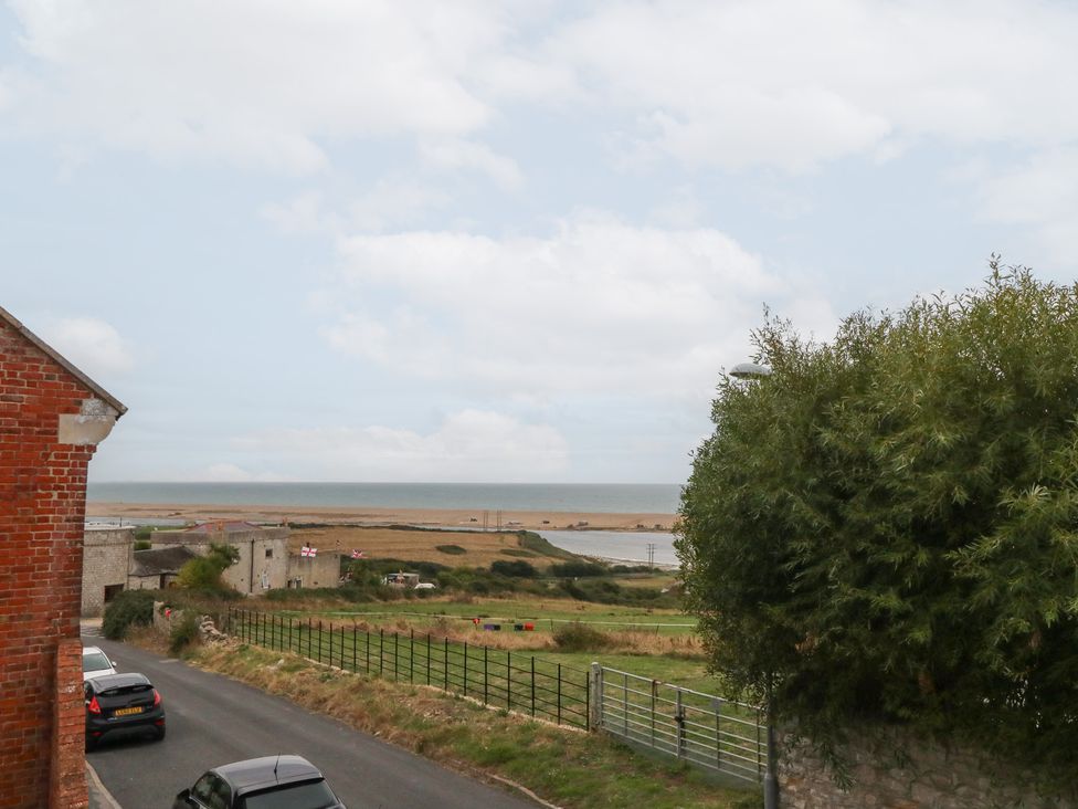 A view of the ocean and fields from a roadside at Coastguard Lookout in Wyke Regis