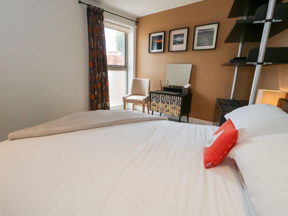 A bedroom with a bed and chair at Coastguard Lookout Wyke Regis