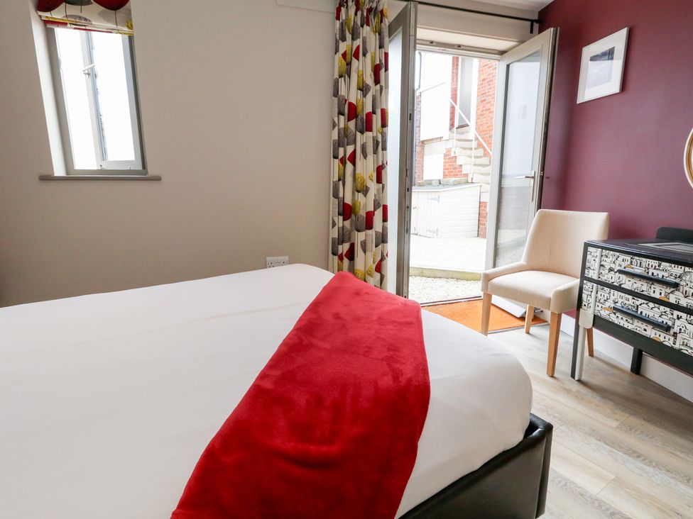 A bedroom with bed and dresser at Coastguard Lookout in Wyke Regis