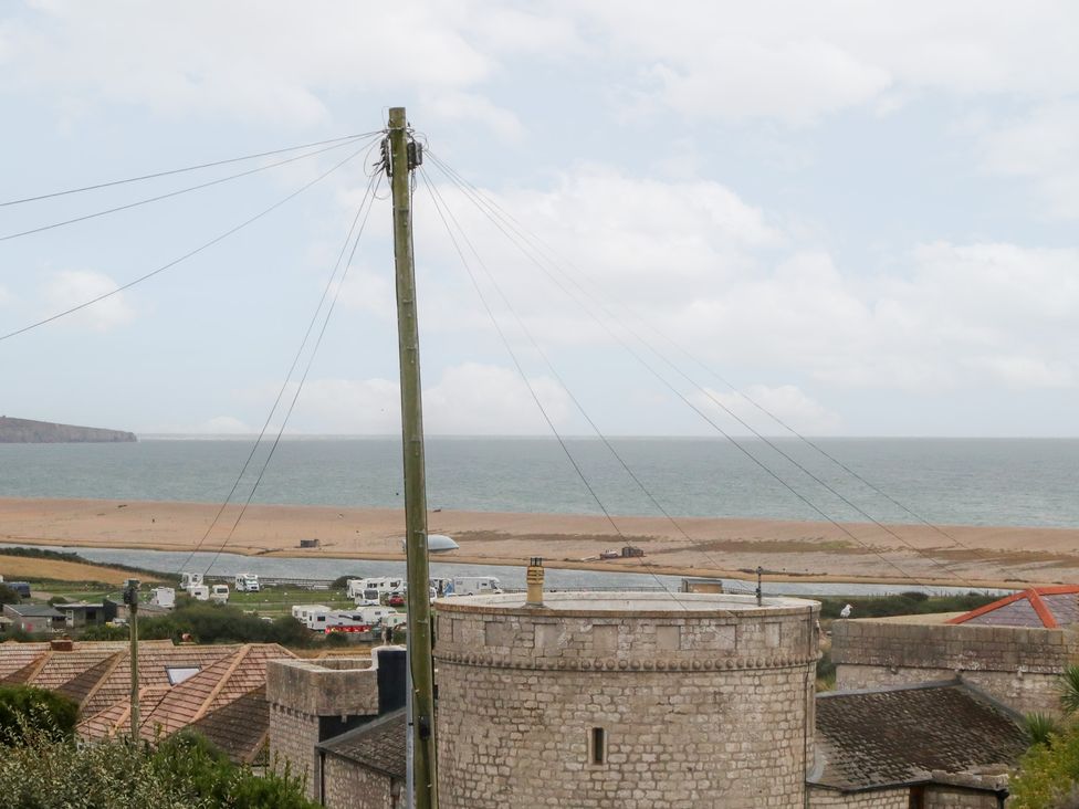 A view of the beach and sea with power lines at Coastguard Lookout in Wyke Regis