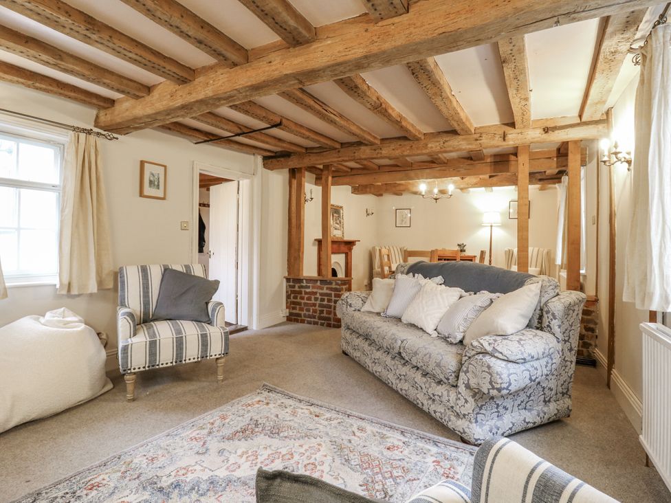 A living room with a sofa and armchair at White Gates in Banham