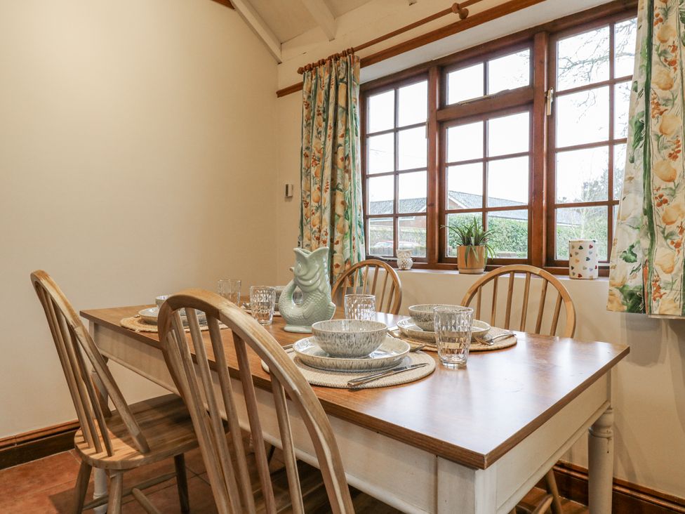 A dining room with a table and chairs at White Gates in Banham