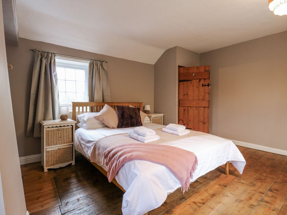 A bedroom with a bed and window at White Gates in Banham