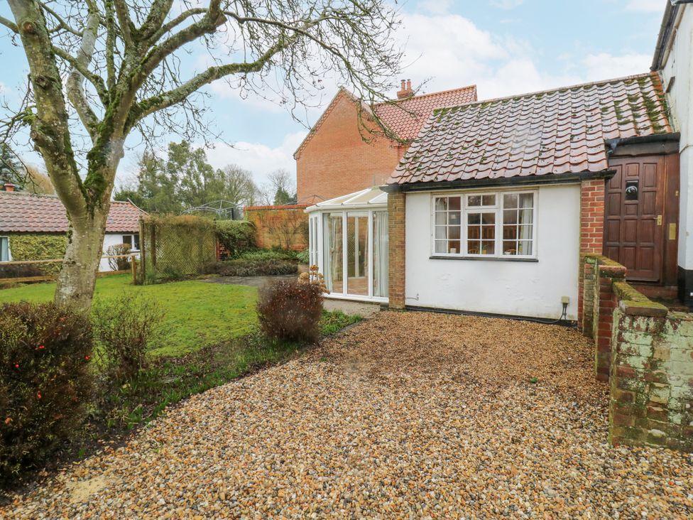 An outdoor area with a house and garden at White Gates in Banham