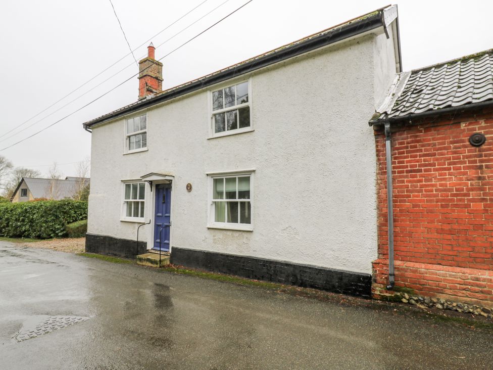 A house exterior view with a blue door at White Gates in Banham