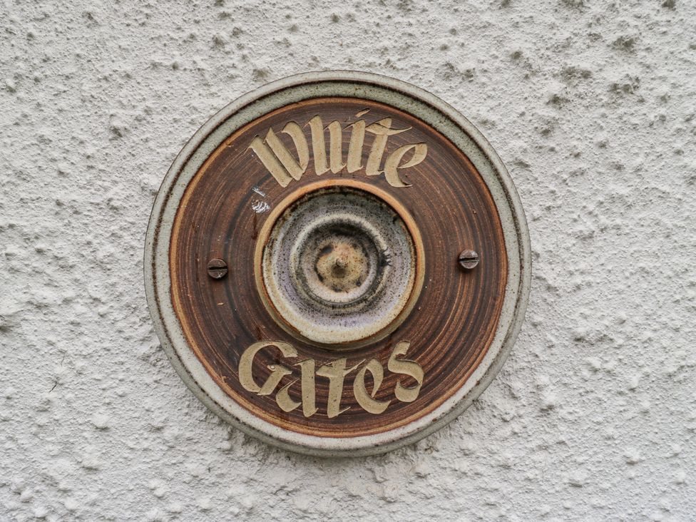 A nameplate fixed to a wall at White Gates in Banham