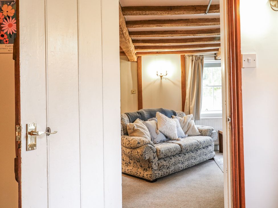 A living room with a sofa and cushions at White Gates in Banham