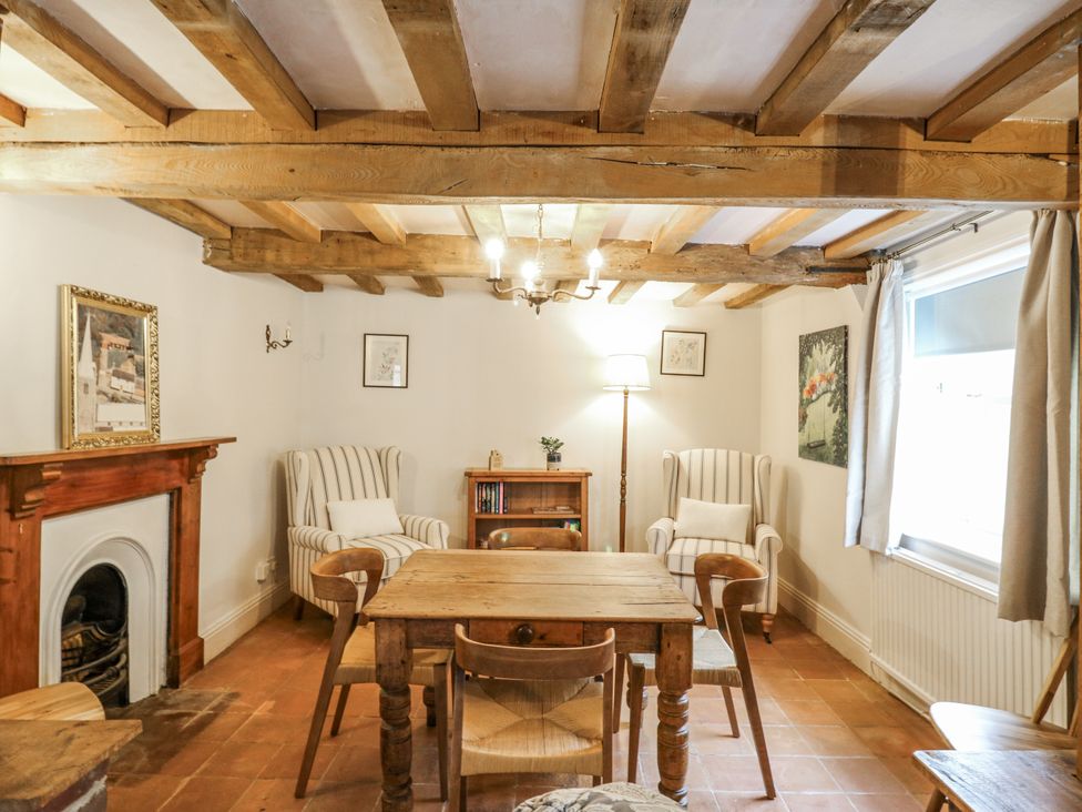 A sitting room with a wooden table and chairs at White Gates in Banham