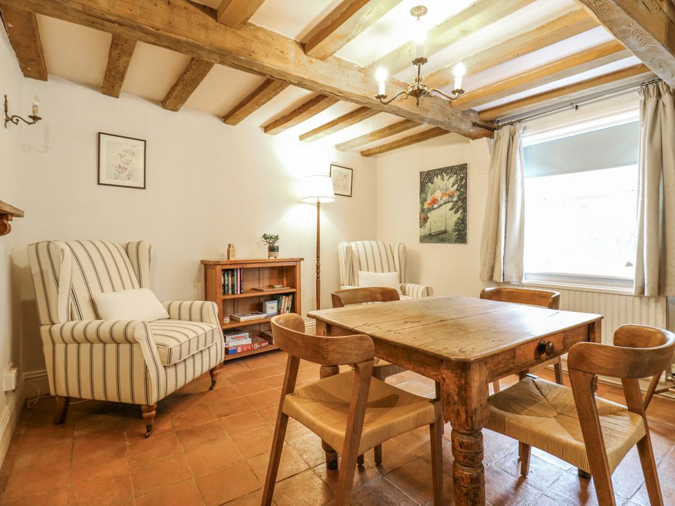 A dining room with a wooden table and chairs at White Gates in Banham
