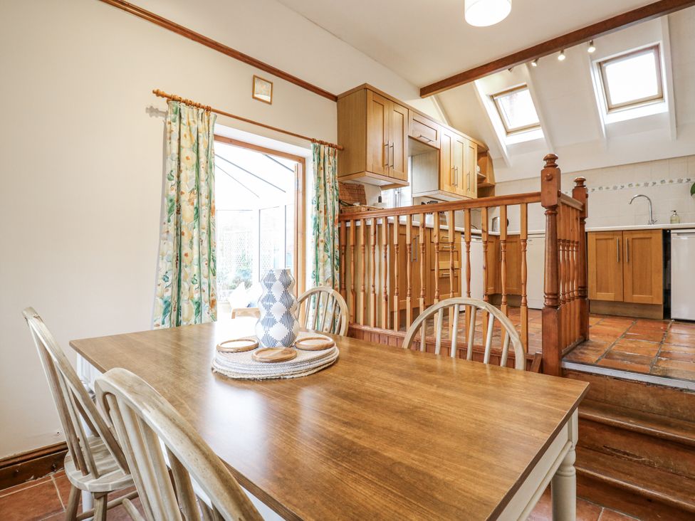 A dining room with a table and chairs at White Gates in Banham