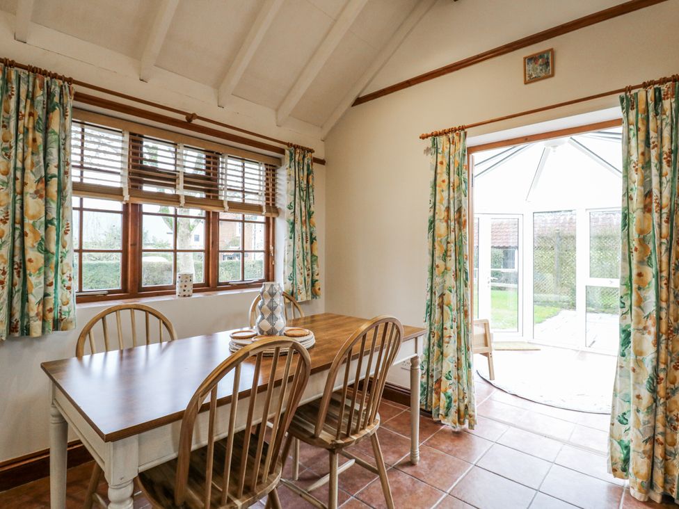A dining room with a table and chairs at White Gates in Banham