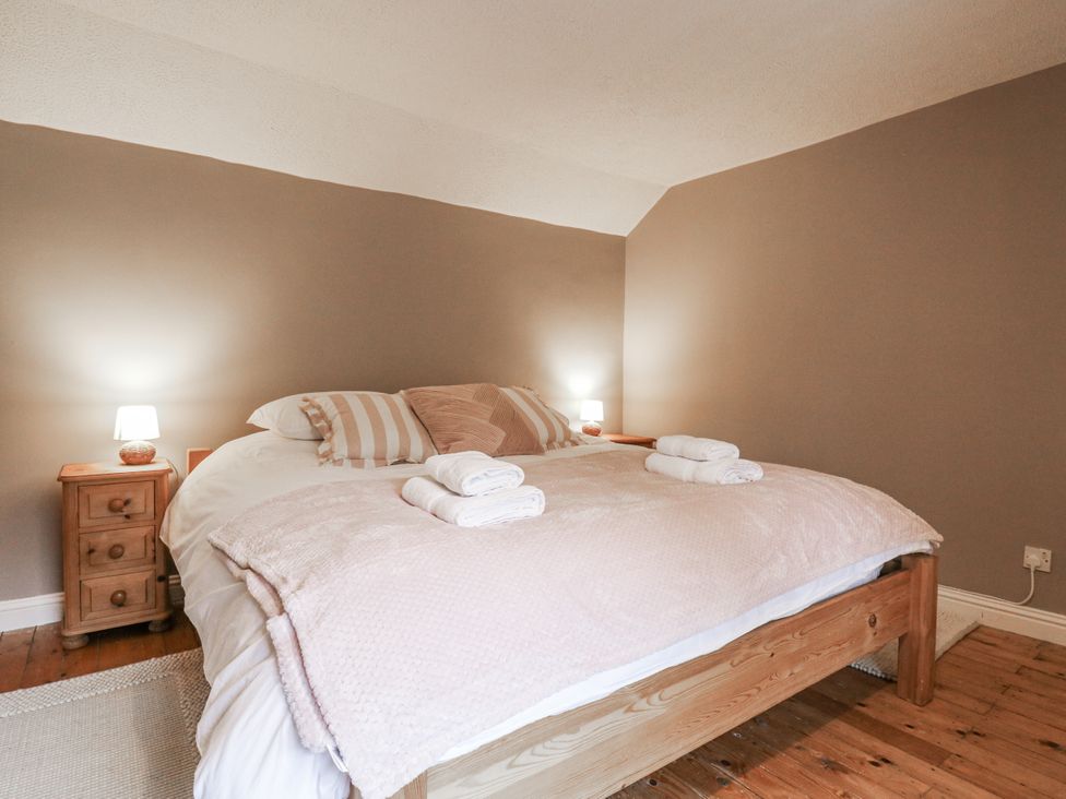 A bedroom with a bed and bedside table at White Gates in Banham