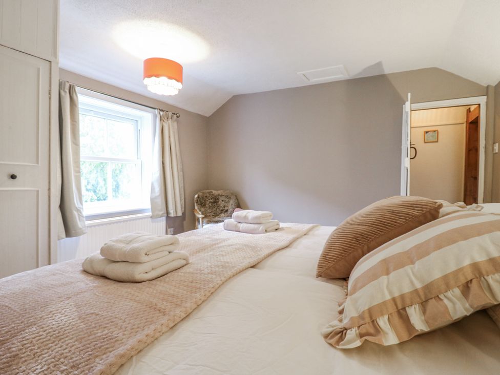 A bedroom with a bed and window at White Gates in Banham