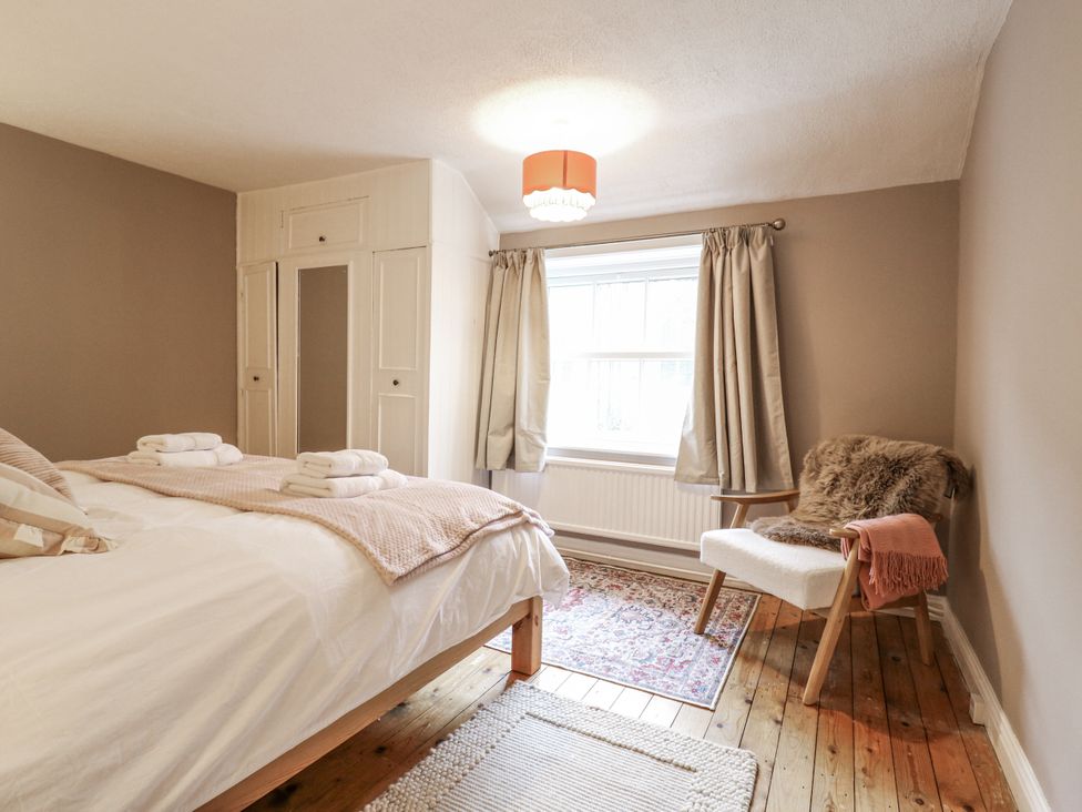 A bedroom with a bed and wardrobe at White Gates in Banham