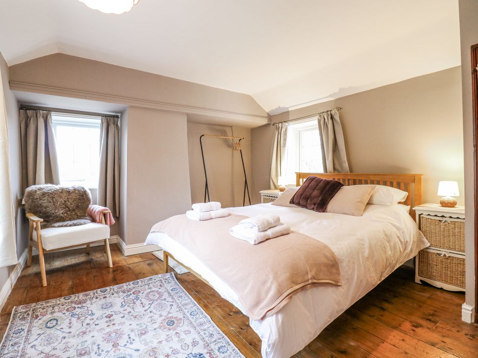 A bedroom with a bed and bedside table at White Gates in Banham