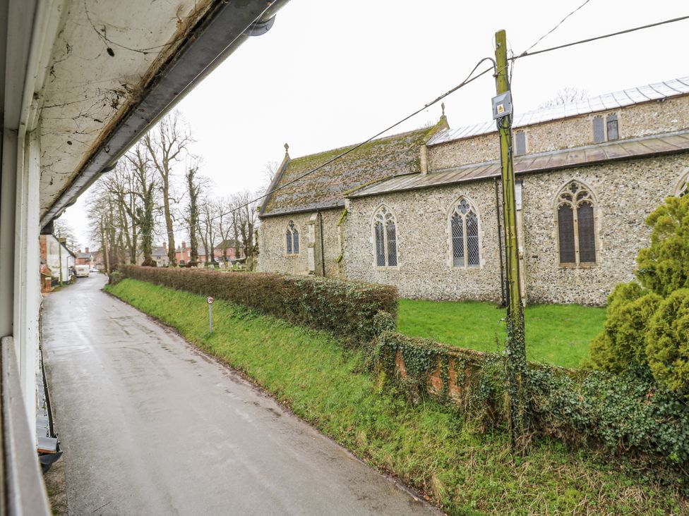 A view of a church and road from a window at White Gates in Banham