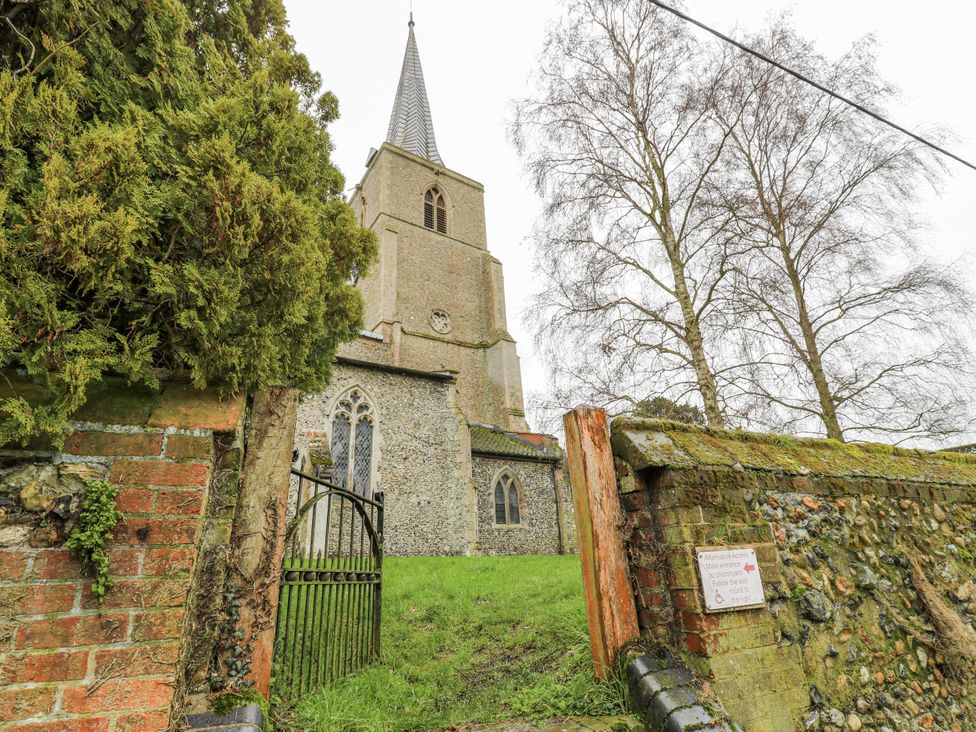 A church building behind a gate at White Gates in Banham