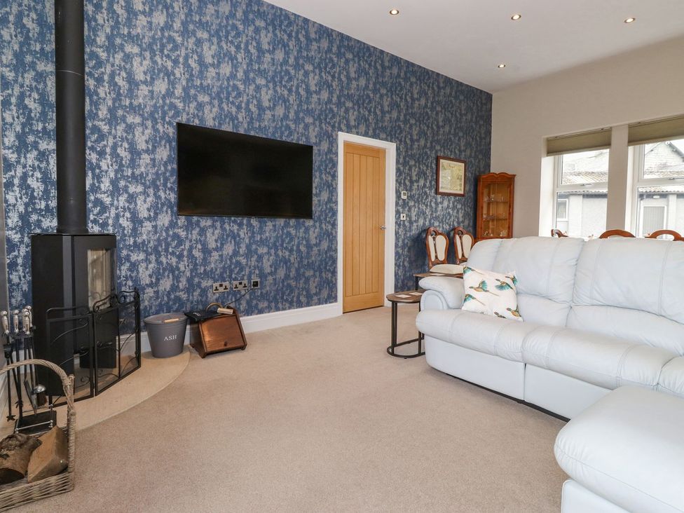 A living room with a sofa and television at The Gatehouse 