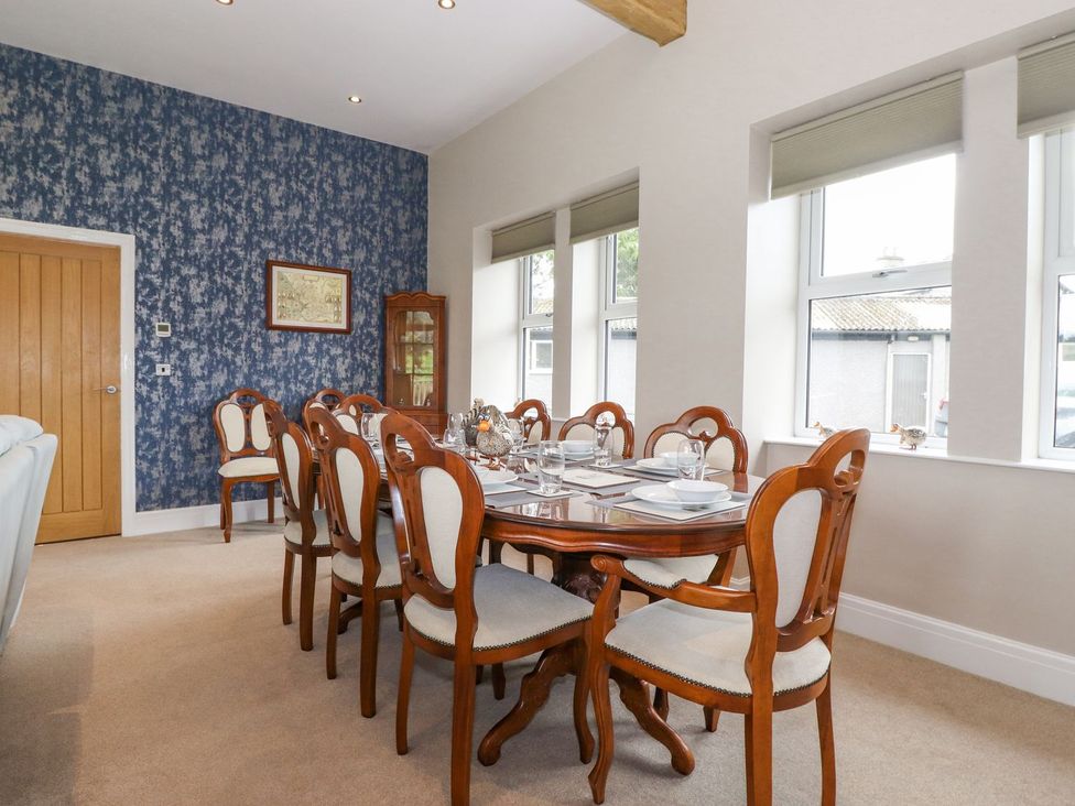 A dining room with a wooden table and chairs at The Gatehouse