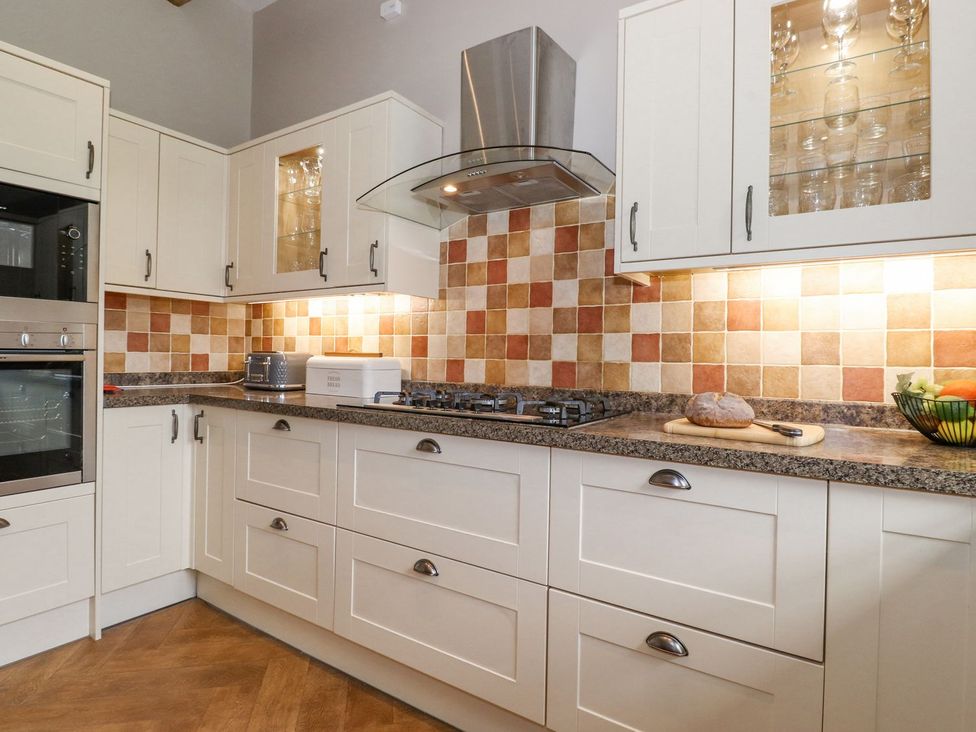A kitchen with cabinets and countertop at The Gatehouse