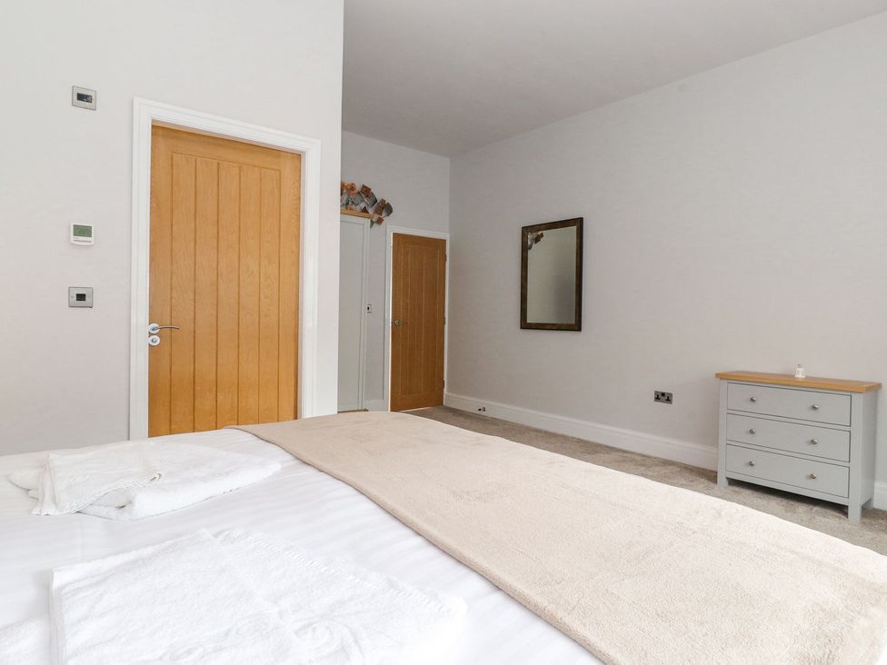 A bedroom with a bed and dressing table at The Gatehouse in 