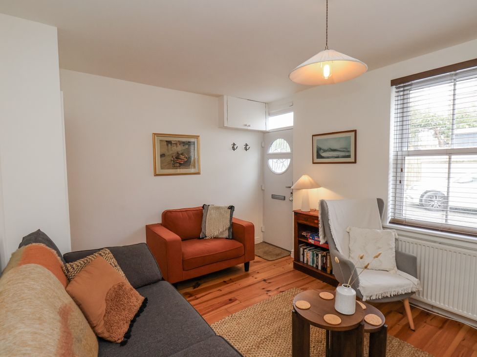 A living room with a sofa and armchair at Launcher's Cottage in Scarborough
