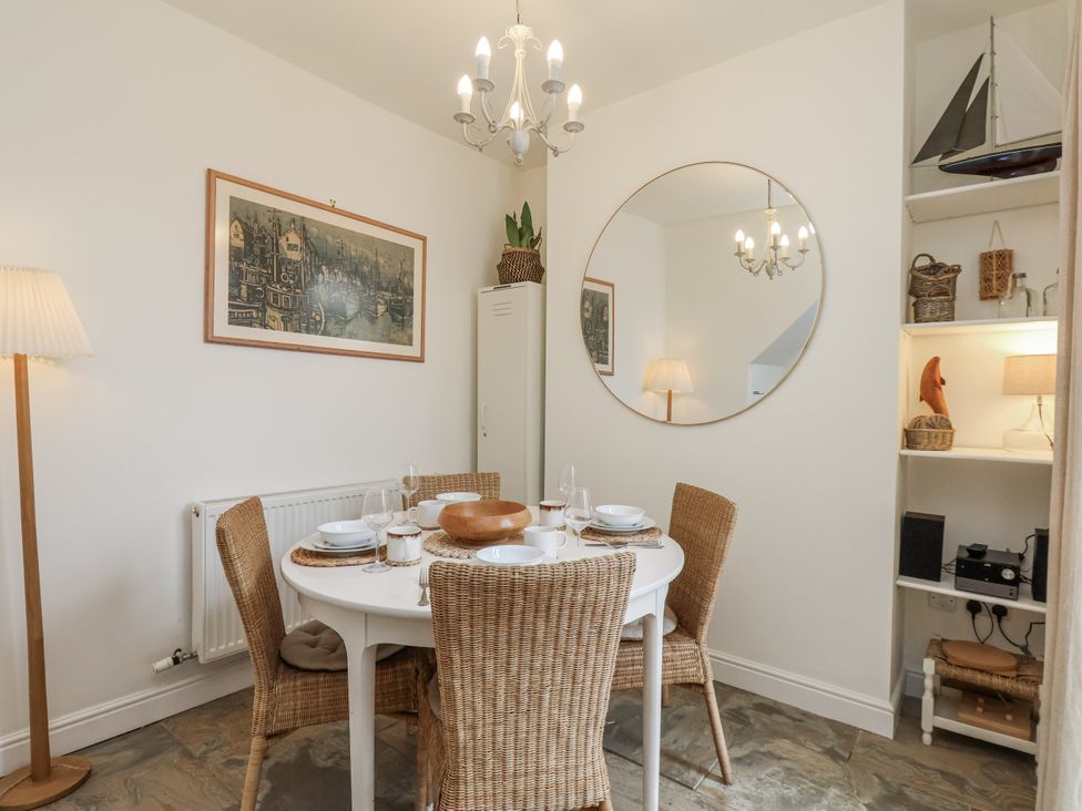 A dining area with a table and chairs at Launcher's Cottage in Scarborough