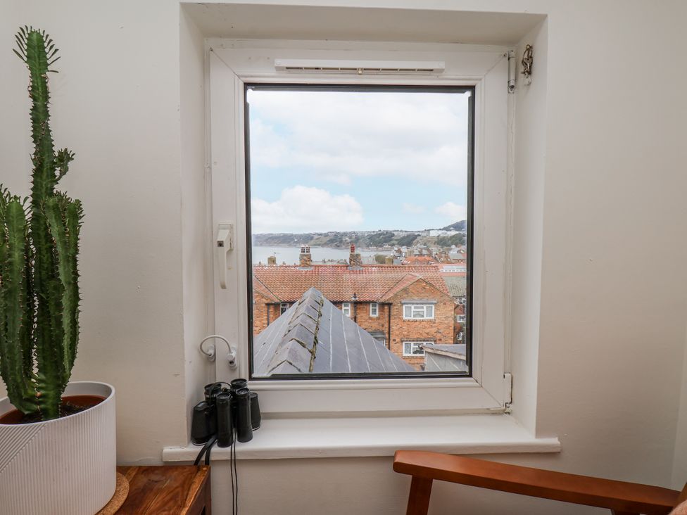 A window with a view and a cactus inside Launcher's Cottage Scarborough