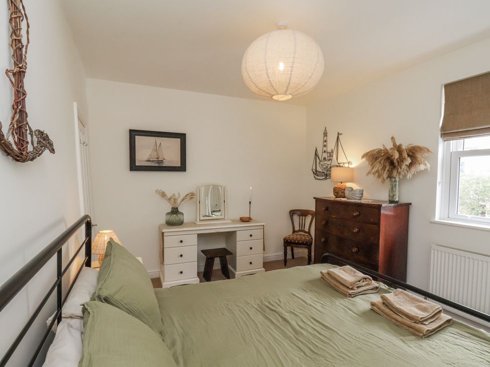 A bedroom with a bed and decorations at Launcher's Cottage in Scarborough